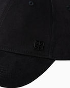 Close-up of Calvin Klein emblem detail on front of cap

