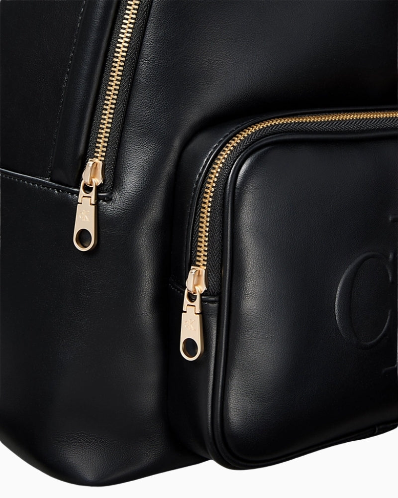Close-up of Calvin Klein embossed monogram on backpack