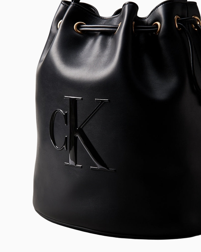 Close-up of tonal embossed Calvin Klein logo on bucket bag