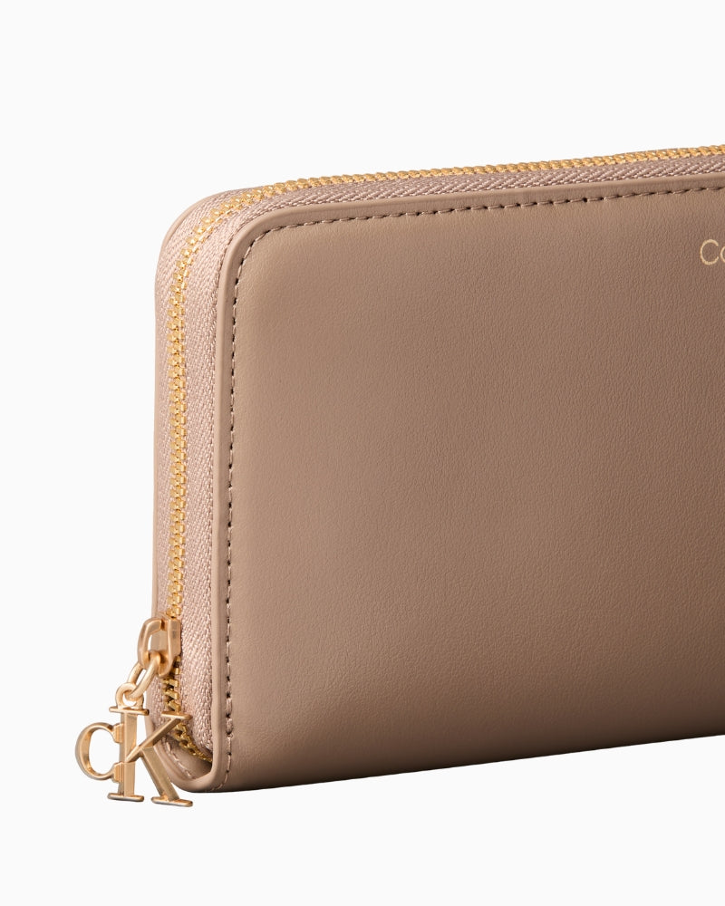 Calvin Klein desert taupe wallet side view with zip detail – Áines Boutique