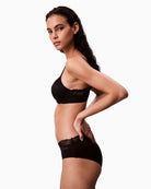 Side view of Calvin Klein lightly lined black bra with full coverage underwired cups