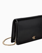 Side view of structured faux leather wallet with flap closure