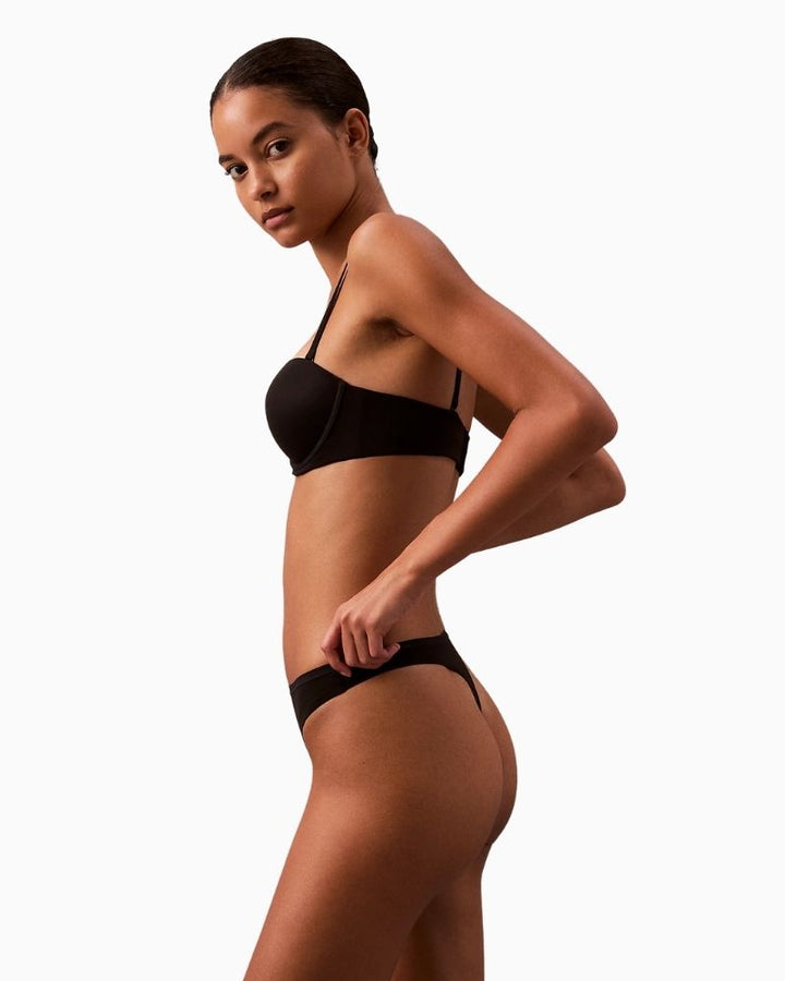 Side view of Calvin Klein Perfectly Fit Thong showing medium-rise fit and smooth fabric