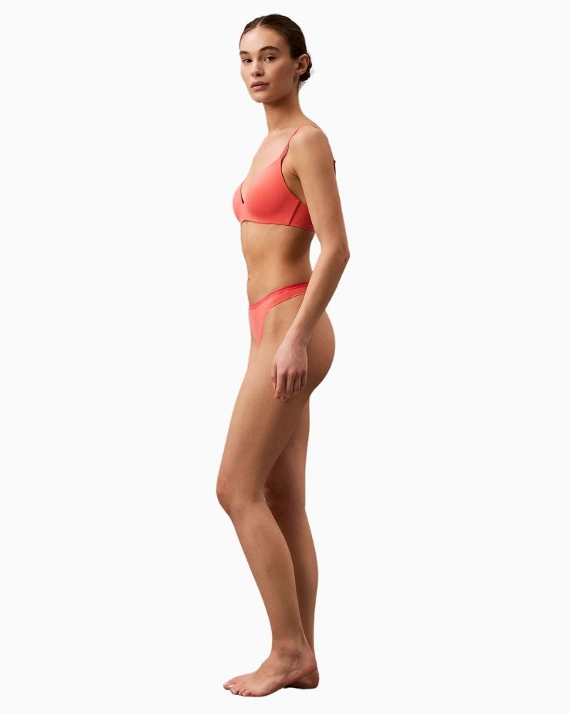 Side view of Calvin Klein recycled microfiber thong in violet shade