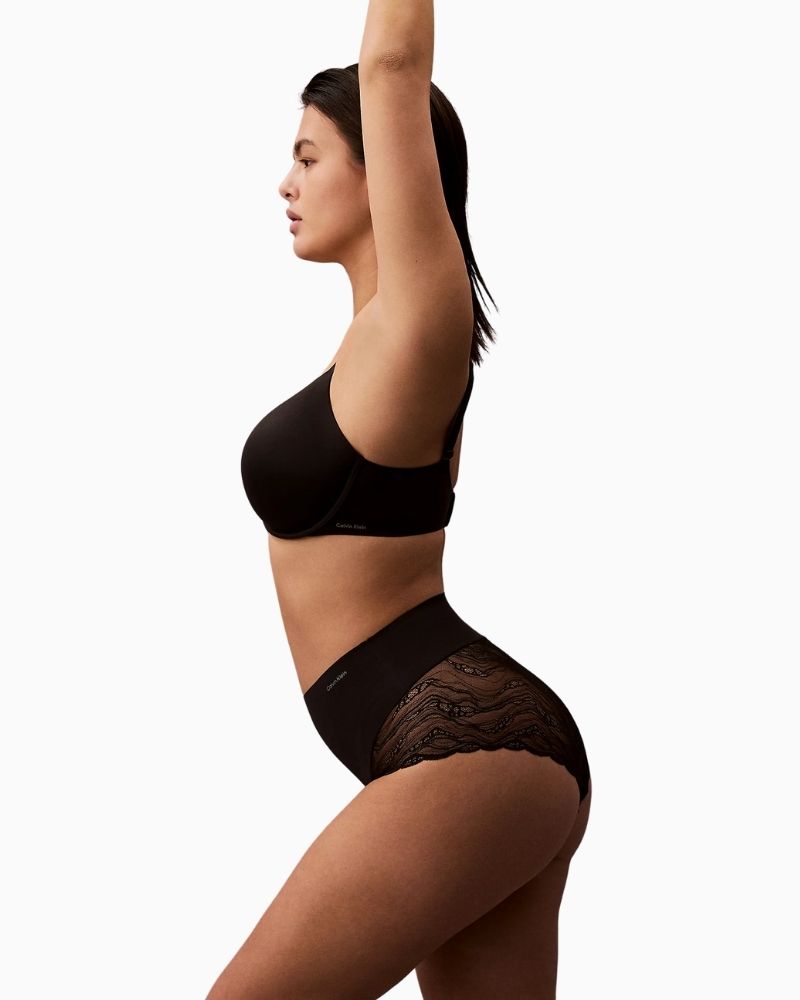 Side view of Calvin Klein Sensual Stretch Lace Shapewear Brief in black showing sheer lace back