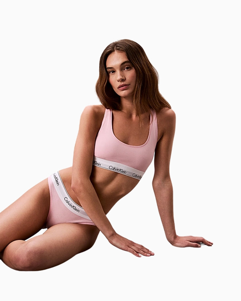 Seated model in pink Calvin Klein thong and bralette set