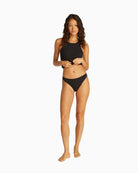 Full body front view of model in black bikini briefs and bra