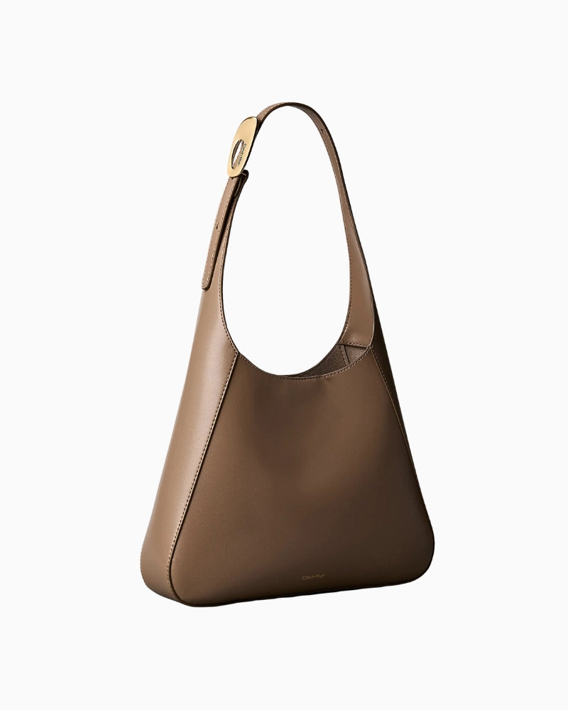Calvin Klein engraved medium shoulder bag taupe side view with strap – Áines Boutique