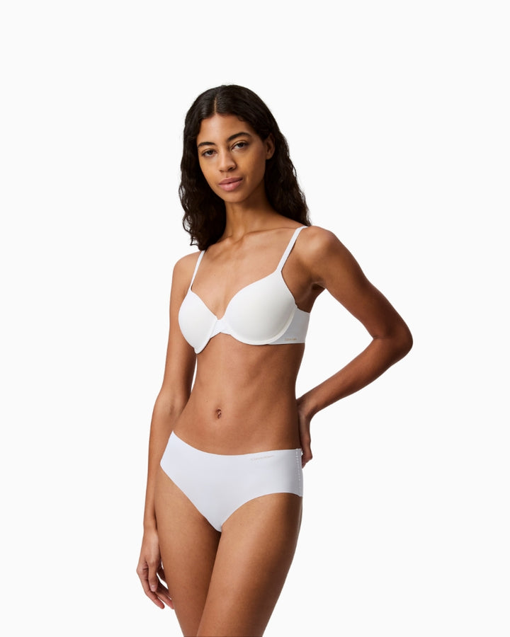 Side view showing seamless fit and natural shaping of Calvin Klein white bra