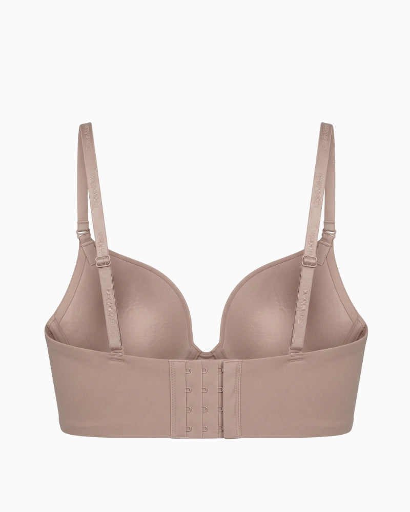 Calvin Klein Lightly Lined Minimal Plunge Bra in nude back view with adjustable branded straps