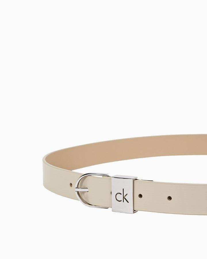 Close-up of Calvin Klein monogram pattern on beige belt