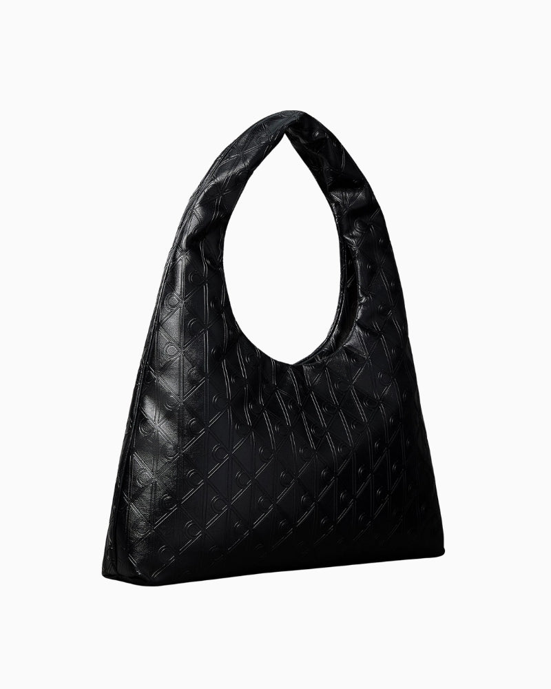 Calvin Klein puffer emblem logo shoulder bag, angled side view highlighting soft structure – Áines Boutique