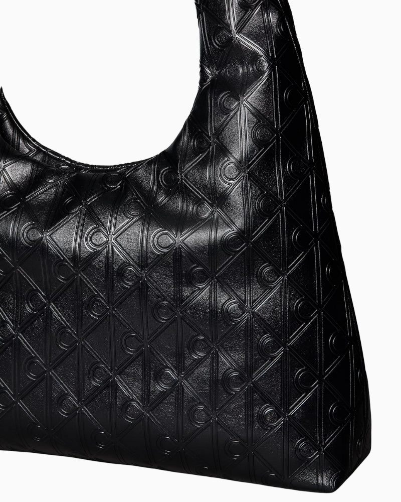 Calvin Klein puffer emblem logo shoulder bag, close-up detail of emblem and texture – Áines