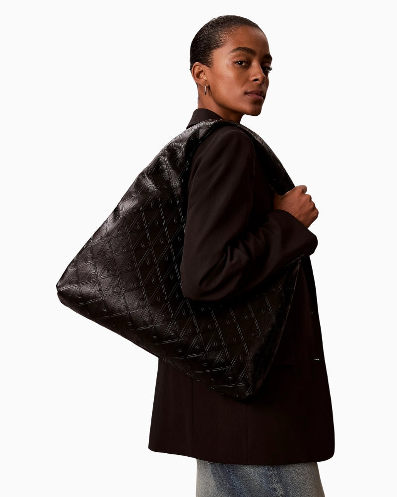 Calvin Klein puffer emblem logo shoulder bag,worn by model paired with casual outfit – Áines Boutique