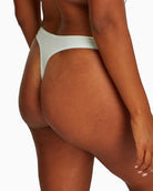 Close-up of Calvin Klein thong showing soft stretch fabric in moonlight jade