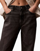 Close-up of rigid denim texture and branded hardware