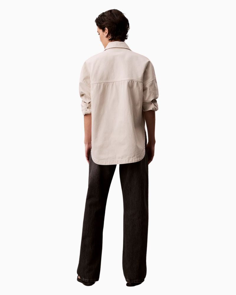Back view of jeans with leather Calvin Klein patch and five-pocket design

