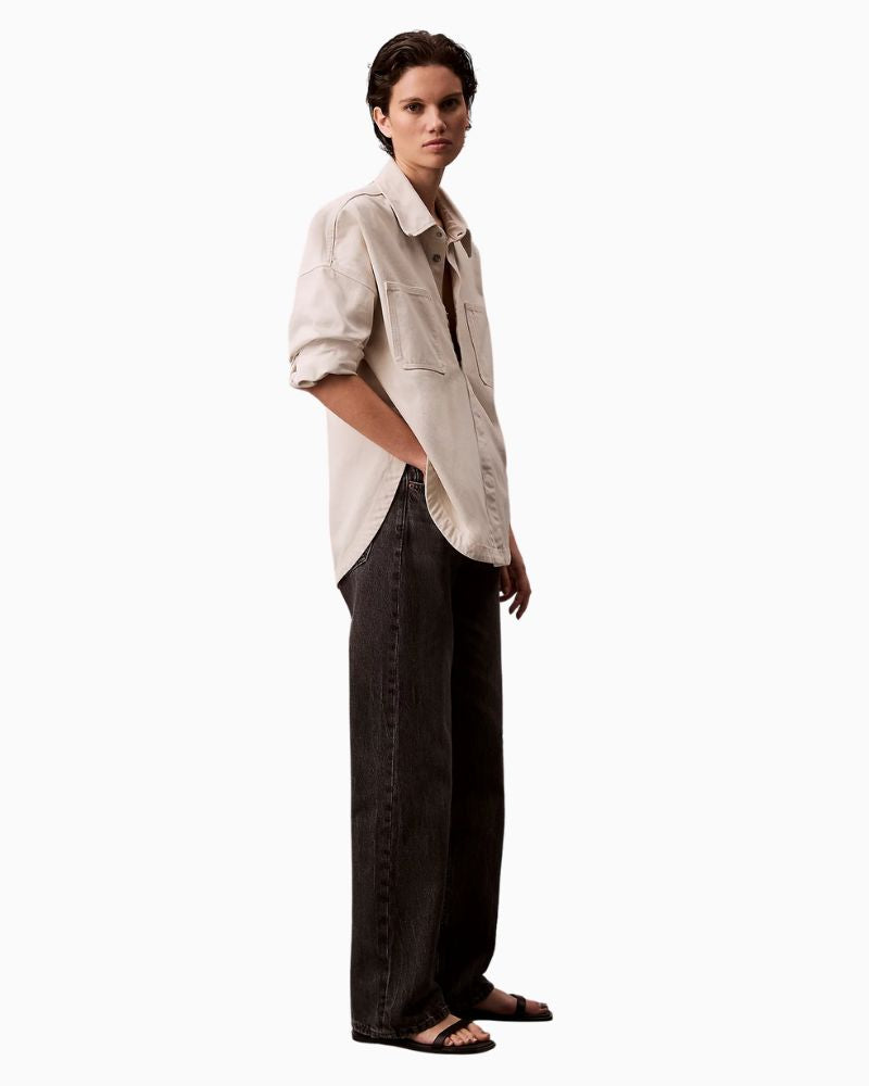 Side view showing straight leg fit and button fly detail