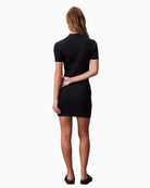 Baack of Calvin Klein Naia dress in navy nylon blend with smooth, minimal silhouette
