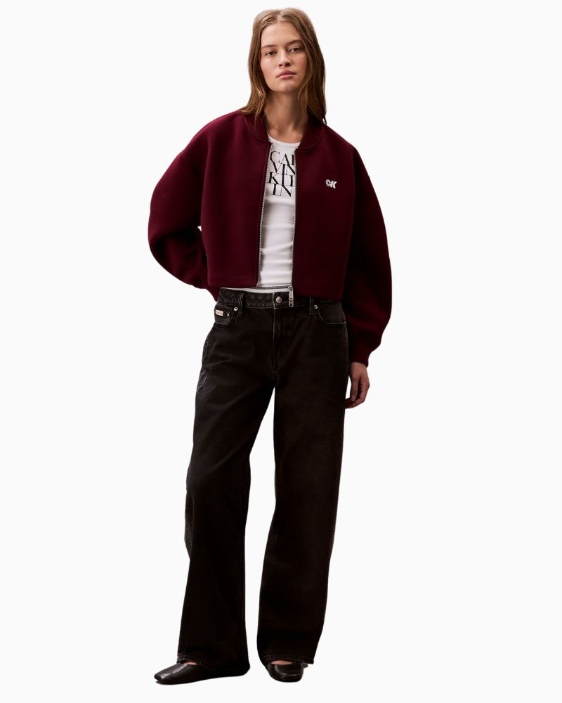 Calvin Klein red jacket styled casually with jeans and trainers