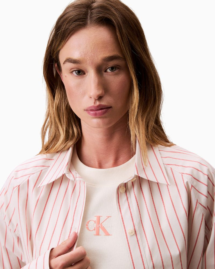 Close-up of stripe detail, collar, and button fastening