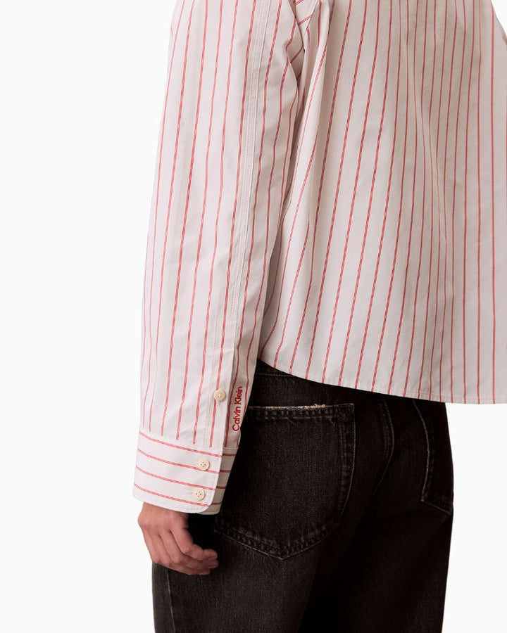 Close-up of stripe detail, collar, and button fastening