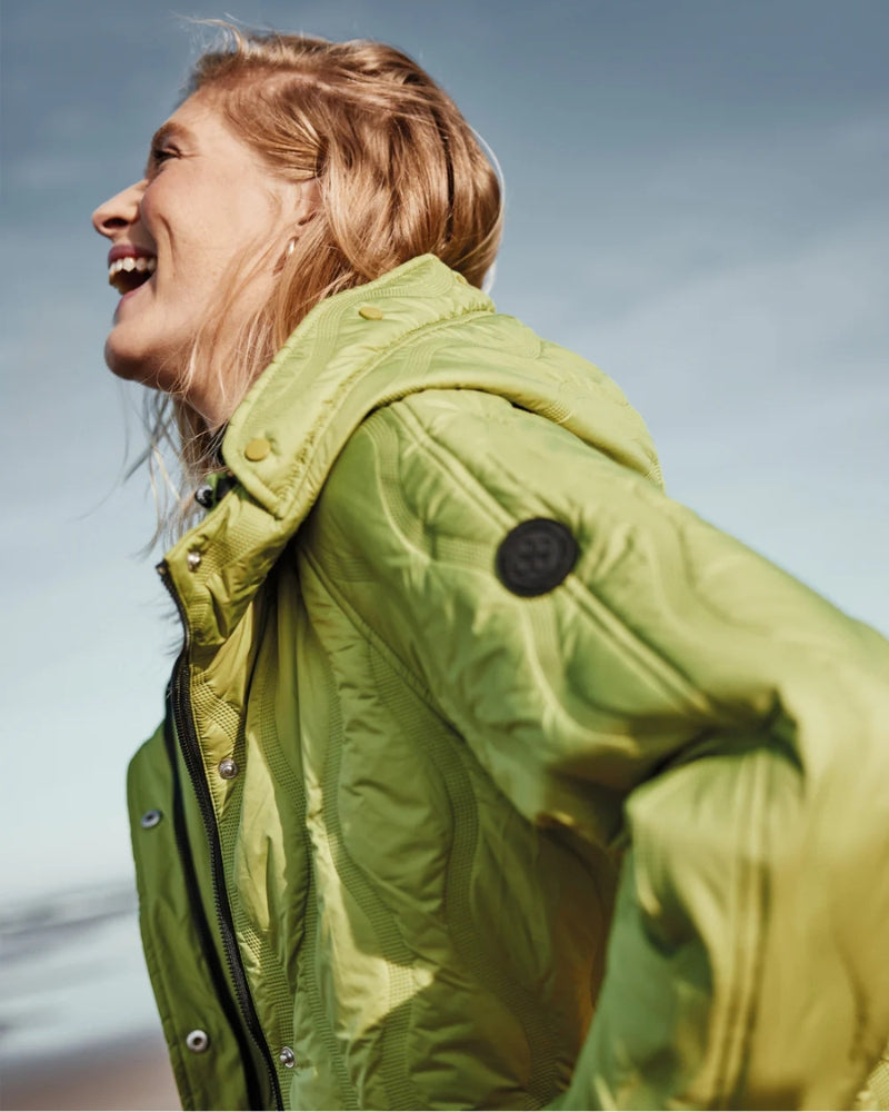 Side view showing contrast black zips and wave quilt detail