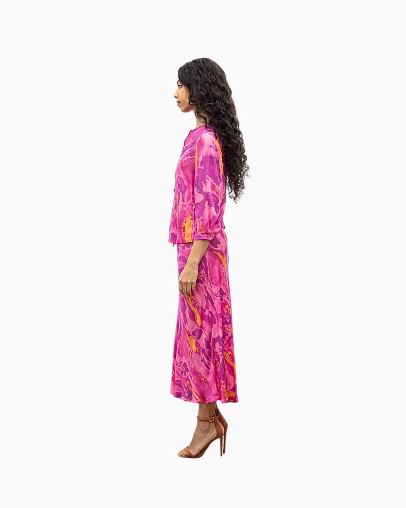 Side view of long-sleeve tie dye blouse in vibrant pink and purple tones