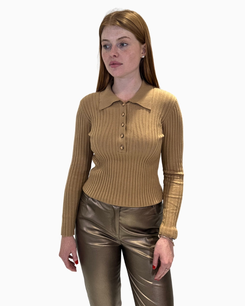 Front view of a woman wearing a slim-fit, ribbed knit polo jumper by Eva Kayan in beige.