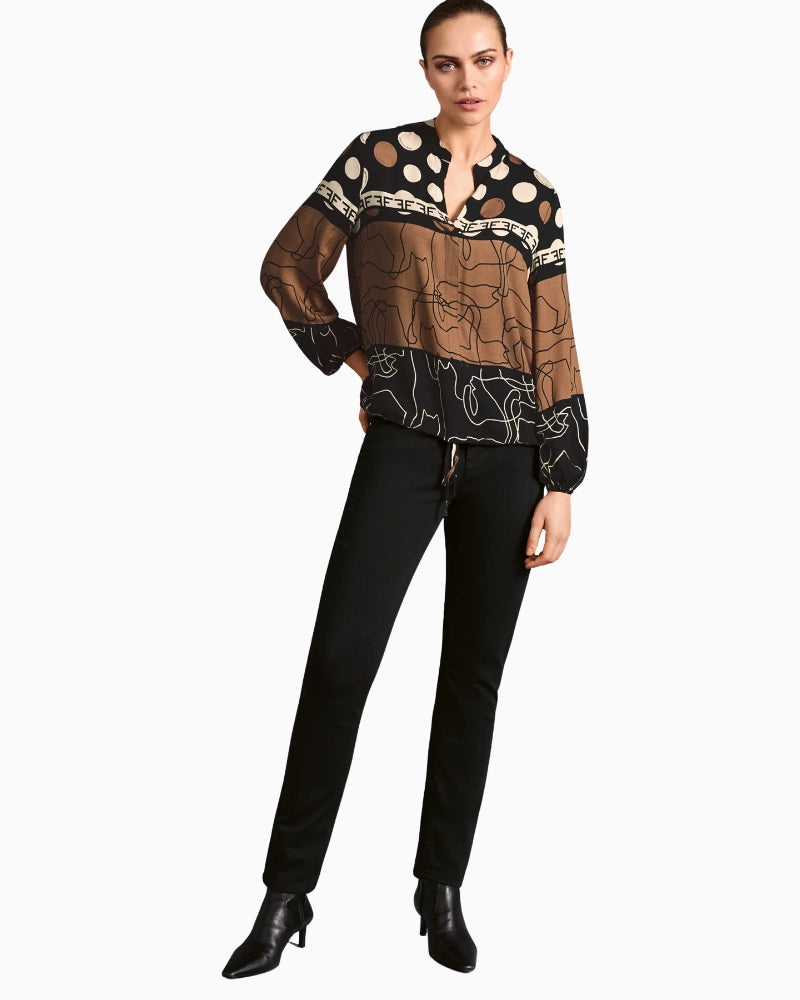 Model wearing V-neck blouse styled with black trousers – side angle