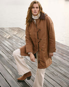 Frandsen Parka Jacket in tan styled front view by the water