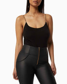 Front view of Freddy eco-leather trousers with lace-up waist detail