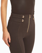 Close-up of waistband and gold button finish on mocha trousers