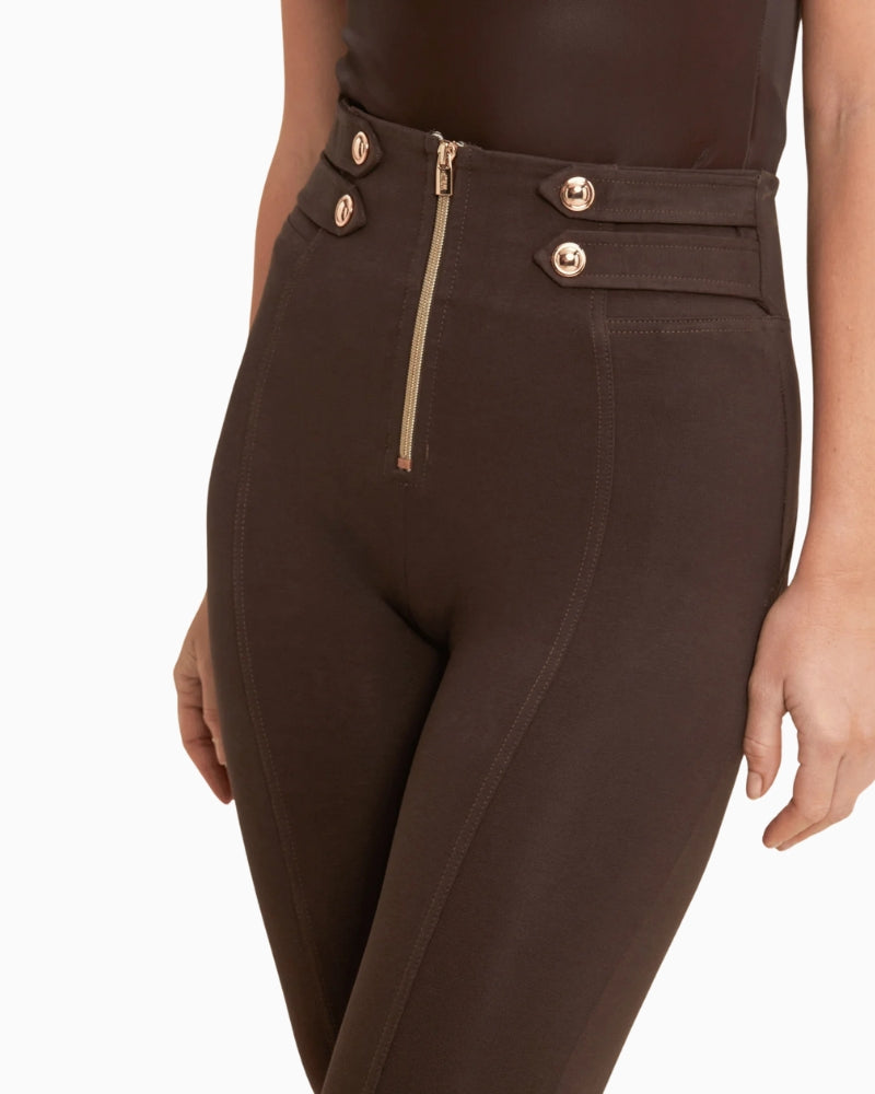 Close-up of waistband and gold button finish on mocha trousers
