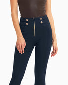 Close-up of waistband and gold button detail on midnight navy trousers