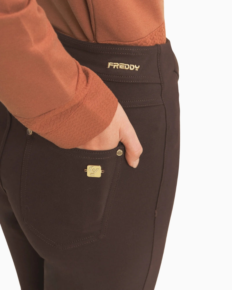 Close-up of waistband and pocket detail on chocolate brown Freddy trousers