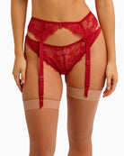 Close-up of gold ring and ribbon detail on cherry red Freya suspender