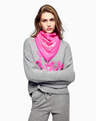 Model wearing From Future pink cashmere bandana scarf in soft cosmic pink shade