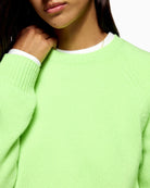 Close-up of ribbed cuffs and soft cashmere knit texture in green