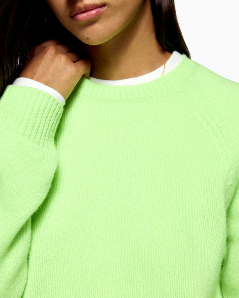Close-up of ribbed cuffs and soft cashmere knit texture in green