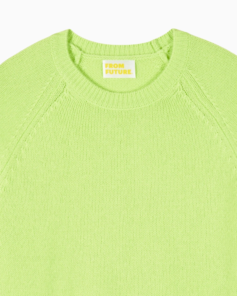 Detail view of neckline and fine knit finish on green cashmere sweater
