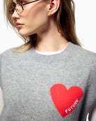 Close-up of “FUTURE” heart embroidery on grey cashmere knit
