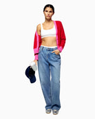 Styled look showing From Future red cashmere cardigan worn open with jeans