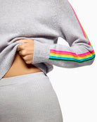 Close-up of sleeve stripe detail on light grey cashmere sweater