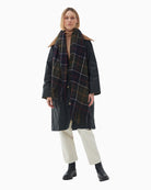 Full length styling of Barbour tartan scarf layered over coat outfit