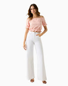 GUESS Off Shoulder Eyelets Top in peach front view on model