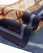 Flat lay of Guess blue logo scarf with bold print and elegant finish