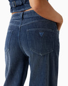 Detail of pocket stitching on dark blue Guess jeans
