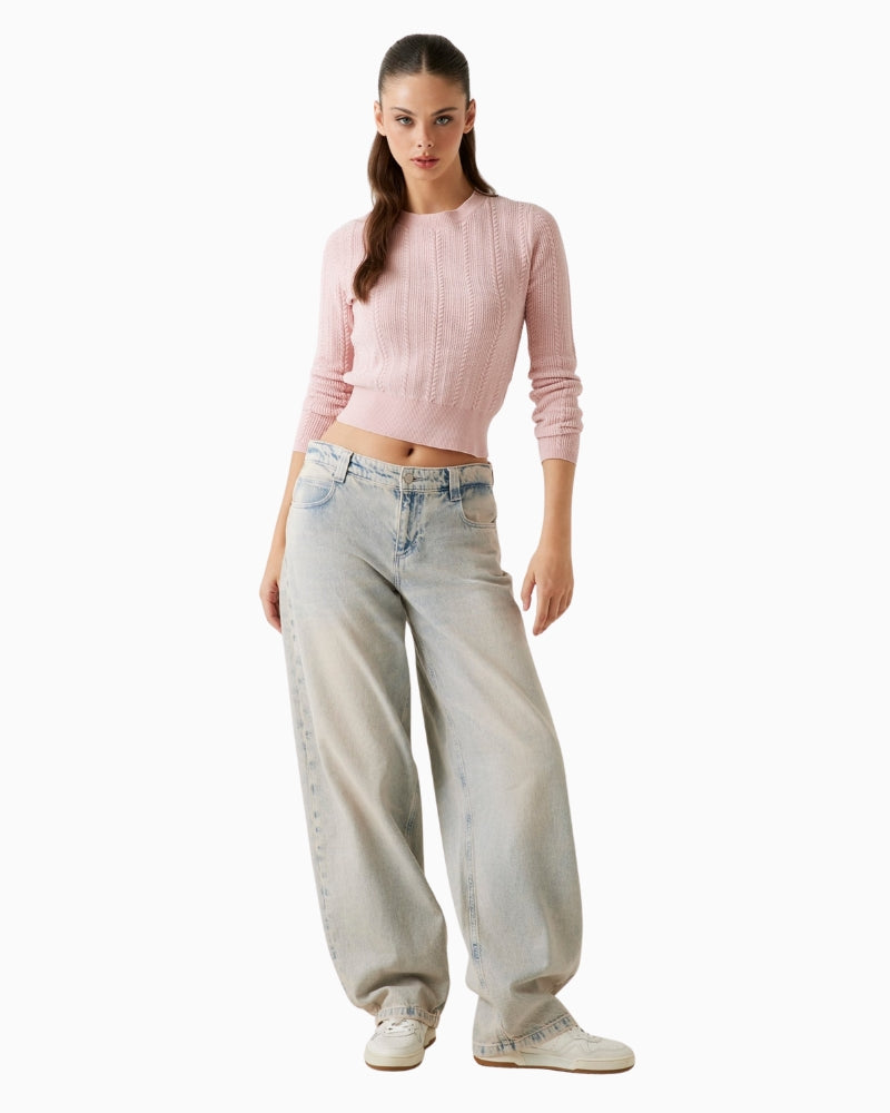Model view of cropped cable knit sweater showing sleeve length