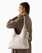 Woman wearing Guess Darcy hobo bag stone  – Áines Boutique